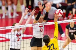 Nebraska Cornhusker Andi Jackson (15) and Nebraska Cornhusker Bergen Reilly (2) prepare for a spike from Michigan Wolverine Kendall Murray (27) in the third set during the volleyball match on Friday, November 17, 2023, in Lincoln, Nebraska. Photo by John S. Peterson.
