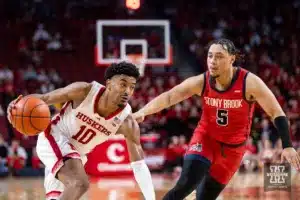 Nebraska Cornhusker guard Jamarques Lawrence (10) dribbles the ball against Stony Brook Seawolf guard Aaron Clarke (5) in the second half during the basketball game on Wednesday, November 15, 2023, in Lincoln, Nebraska. Photo by John S. Peterson.