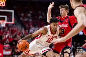 Nebraska Cornhusker guard Jamarques Lawrence (10) drives into Stony Brook Seawolf guard Dean Noll (13) in the second half during the basketball game on Wednesday, November 15, 2023, in Lincoln, Nebraska. Photo by John S. Peterson.