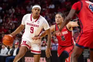 Nebraska Cornhusker guard Jarron Coleman (9) dribbles the ball against Stony Brook Seawolf guard Aaron Clarke (5) in the second half during the basketball game on Wednesday, November 15, 2023, in Lincoln, Nebraska. Photo by John S. Peterson.