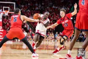 Nebraska Cornhusker forward Juwan Gary (4) dribbles between Stony Brook Seawolf guard Aaron Clarke (5) and guard Dean Noll (13) in the second half during the basketball game on Wednesday, November 15, 2023, in Lincoln, Nebraska. Photo by John S. Peterson.