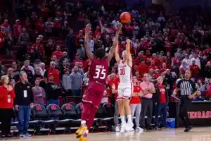 Nebraska Cornhusker guard Keisei Tominaga (30) makes a three point basket against Rider Bronc Tyriek Weeks in the first half during the basketball game on Monday, November 13, 2023, in Lincoln, Nebraska. Photo by John S. Peterson.