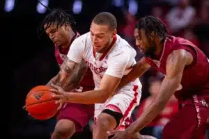 Nebraska Cornhusker guard C.J. Wilcher (0) fights for the ball against Rider Bronc forward Tariq Ingraham (33) and Tyrieks Weeks in the second half during the basketball game on Monday, November 13, 2023, in Lincoln, Nebraska. Photo by John S. Peterson.