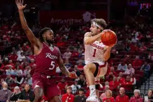 Nebraska Cornhusker guard Sam Hoiberg (1) makes a pass against Rider Bronc forward Mervin James (5) in the second half during the basketball game on Monday, November 13, 2023, in Lincoln, Nebraska. Photo by John S. Peterson.