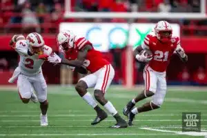 Nebraska Cornhusker running back Emmett Johnson (21) runs with the football with wide receiver Malachi Coleman (15) blocking Maryland Terrapin defensive back Beau Brade (2)  during the football game on Saturday, November 11, 2023, in Lincoln, Nebraska. Photo by John S. Peterson.