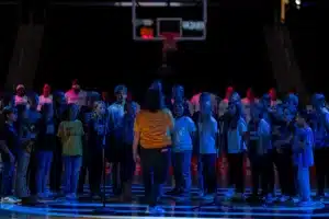 Local school children sing the National Anthem during a game between College of Saint Mary and the UN-Omaha in Omaha, NE on Wednesday November 8th, 2023. . Photo by Eric Francis