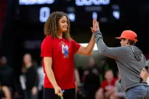 Rebbeca Alick gives five to a young Husker fan after jumping rope before the game against the Northwestern State Lady Demons on Monday, November 6, 2023, in Lincoln, Nebraska. Photo by John S. Peterson.