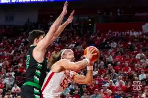 Nebraska Cornhusker forward Josiah Allick (53) makes a layup against North Dakota Fighting Hawk guard Treysen Eaglestaff (52) in the second half during a college basketball game Wednesday, December 20, 2023, in Lincoln, Nebraska. Photo by John S. Peterson.
