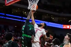 Nebraska Cornhusker guard Brice Williams (3) makes a layup against North Dakota Fighting Hawk forward Deng Mayar (5) in the first half during a college basketball game Wednesday, December 20, 2023, in Lincoln, Nebraska. Photo by John S. Peterson.