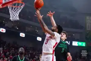 Nebraska Cornhusker guard Brice Williams (3) makes a layup against North Dakota Fighting Hawk forward Amar Kuljuhovic (3) in the first half during a college basketball game Wednesday, December 20, 2023, in Lincoln, Nebraska. Photo by John S. Peterson.