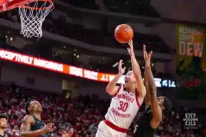 Nebraska Cornhusker guard Keisei Tominaga (30) makes a basket against Michigan State Spartan guard Tre Holloman (5) in the first half during the college basketball game Sunday, December 10, 2023, Lincoln, Neb. Photo by John S. Peterson.