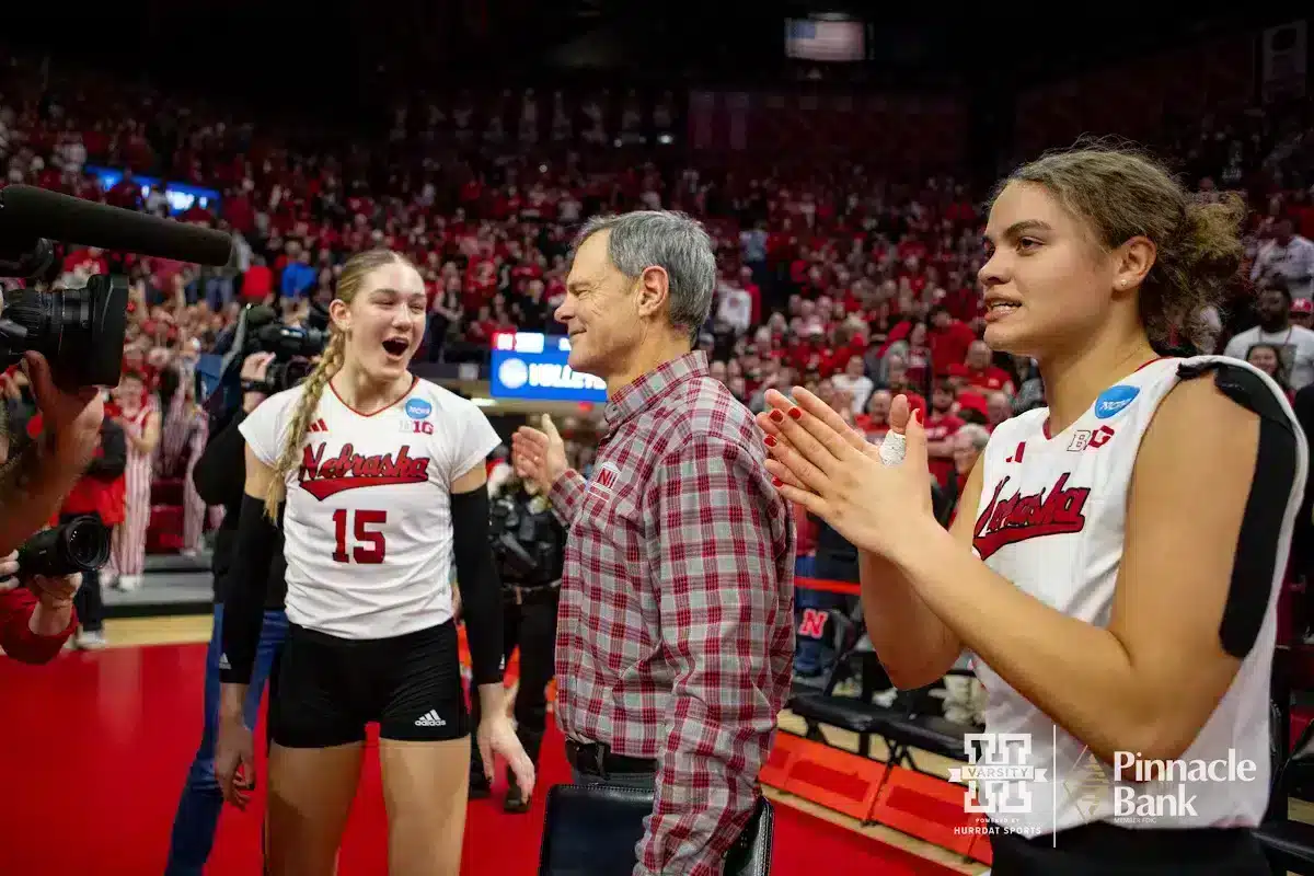 JP231209_VB_NCAA_4th_NU_AR_3979_WM.jpg Nebraska Cornhuskers Andi Jackson (15), John Cook, and Bekka Allick (5) celebrate the win over the Arkansas Razorbacks during the Regional Championship match in the NCAA Volleyball Championship Thursday, December 7, 2023, Lincoln, Neb. Photo by John S. Peterson.