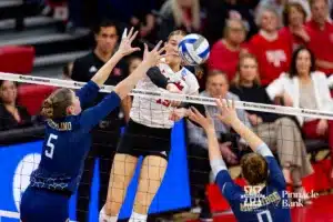Nebraska Cornhusker Andi Jackson (15) spikes the ball against Georgia Tech Yellow Jacket Bianca Bertolino (5) and Georgia Tech Yellow Jacket Liv Mogridge (0) in the second set during the third round in the NCAA Volleyball Championship match Thursday, December 7, 2023, Lincoln, Neb. Photo by John S. Peterson.