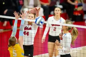 Nebraska Cornhusker Maggie Mendelson (44) dunks the ball on Long Island Shark setter Allie Merz (5) in the second set during the first round of the NCAA volleyball championships on Friday, December 1, 2023, in Lincoln, Neb. Photo by John S. Peterson.