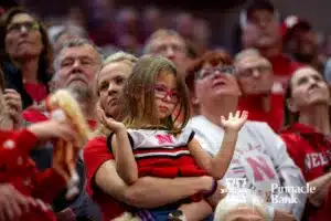 Nebraska Cornhusker fan clapping during the introductions before the start of the first round of the NCAA volleyball championships on Friday, December 1, 2023, in Lincoln, Neb. Photo by John S. Peterson.