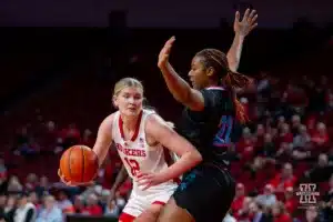 Nebraska Cornhusker forward Jessica Petrie (12) drives to the basket against Florida Atlantic Owl center Dyllan Hanna (22) in the second half during the basketball game on Wednesday, November 29, 2023, in Lincoln, Neb. Photo by John S. Peterson.