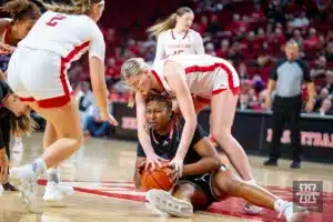 Nebraska Cornhusker forward Jessica Petrie (12) goes after the ball against Florida Atlantic Owl guard Devyn Scott (1) in the second half during the basketball game on Wednesday, November 29, 2023, in Lincoln, Neb. Photo by John S. Peterson.