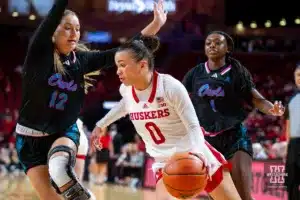 Nebraska Cornhusker guard Darian White (0) drives the baseline against Florida Atlantic Owl guard Allie Tylka (12) in the first half during the basketball game on Wednesday, November 29, 2023, in Lincoln, Neb. Photo by John S. Peterson.
