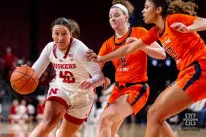 Nebraska Cornhusker guard Maddie Krull (42) drives the lane against Illinois Fighting Illini forward Brynn Shoup-Hill (23) and guard Gretchen Dolan (5) in the second half during a college basketball game on Thursday, January 11, 2024, in Lincoln, Nebraska. Photo by John S. Peterson.