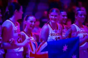 Australian Cornhuskers Jaz Shelley (1) and Jessica Petrie (12) hold the Australian flag while the Australiain National Anthem was played before taking on the Illinois Fighting Illini during a college basketball game on Thursday, January 11, 2024, in Lincoln, Nebraska. Photo by John S. Peterson.