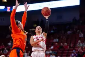 Nebraska Cornhusker guard Darian White (0) puts up a jumper against Illinois Fighting Illini forward Kendall Bostic (44) in the second half during a college basketball game on Thursday, January 11, 2024, in Lincoln, Nebraska. Photo by John S. Peterson.