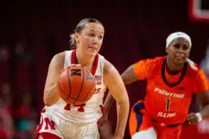 Nebraska Cornhusker guard Callin Hake (14) beats out Illinois Fighting Illini guard Genesis Bryant (1) driving to the basket in the second half during a college basketball game on Thursday, January 11, 2024, in Lincoln, Nebraska. Photo by John S. Peterson.
