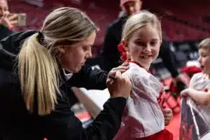 Nebraska Cornhusker guard Allison Weidner makes a young fans day with an autograph after the win against the Illinois Fighting Illini during a college basketball game on Thursday, January 11, 2024, in Lincoln, Nebraska. Photo by John S. Peterson.