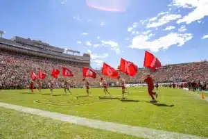 Nebraska Cornhuskers cheer squad runs in the endzone with the flags celebrating a third quarter touchdown during a college football game in Boulder, Colorado, Friday, September 9, 2023. Photo by John Peterson.