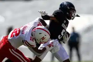 Omar Brown (12) of the Nebraska Cornhuskers tackles wide receiver Jimmy Horn Jr. (5) of the Colorado Buffaloes in the third quarter during a college football game in Boulder, Colorado, Friday, September 9, 2023. Photo by John Peterson.
