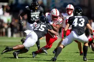 Rahmir Johnson (14) of the Nebraska Cornhuskers stopped by linebacker Marvin Ham II (25) of the Colorado Buffaloes in the second quarter during a college football game in Boulder, Colorado, Friday, September 9, 2023. Photo by John Peterson.
