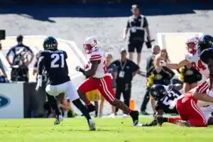 Gabe Ervin Jr. (22) of the Nebraska Cornhuskers runs the ball against Shilo Sanders (21) of the Colorado Buffaloes in the first quarter during a college football game in Boulder, Colorado, Friday, September 9, 2023. Photo by John Peterson.