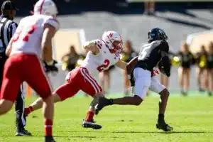 defensive back Isaac Gifford (2) of the Nebraska Cornhuskers reaches out to tackle wide receiver Jimmy Horn Jr. (5) of the Colorado Buffaloes in the first quarter during a college football game in Boulder, Colorado, Friday, September 9, 2023. Photo by John Peterson.