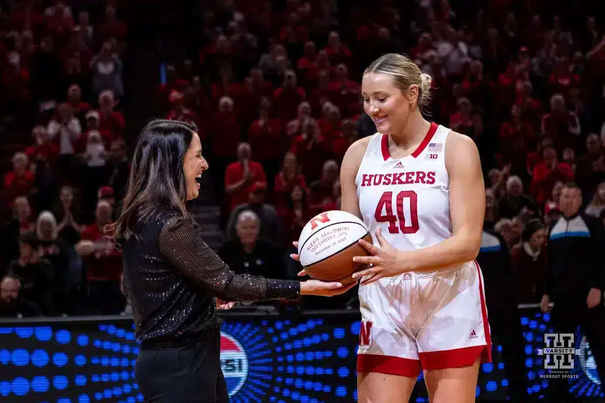 JP231231_MBB_NU_MD_0212_WM.jpg Nebraska Cornhusker head coach Amy Williams hands Alexis Markowski a basketball celebrating 1000 career points before the game against the Maryland Terrapins during a college basketball game on Sunday, December 31, 2023, in Lincoln, Nebraska. Photo by John S. Peterson.
