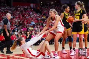 Nebraska Cornhusker forward Jessica Petrie (12) helps guard Kendall Moriarty (15) get up after being fouled in the second quarter against the Iowa Hawkeyes during a college basketball game on Sunday, February 11, 2024, in Lincoln, Nebraska. Photo by John S. Peterson.
