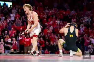 Nebraska Cornhusker No. 19 Jacob Van Dee (15-6) celebrates defeating Michigan Wolverine No. 4 Dylan Ragusin (20-0)  during a college wrestling match on Friday, February 9, 2024, in Lincoln, Nebraska. Photo by John S. Peterson.