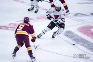 Omaha forward Tanner Ludtke (71) on the attack against Minn. Duluth forward Ben Steeves (6) in the first period during a college hockey match on Friday, February 2, 2024, in Omaha, Nebraska. Photo by John S. Peterson.