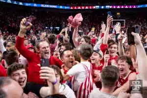 Nebraska Cornhuskers fans crash the court celebrating a win over