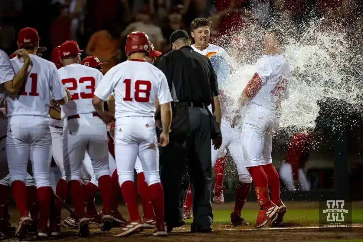 Nebraska Baseball v Indiana – 2024-05-11 Nebraska Cornhusker Cole Evans (12) celebrates hitting a three-run homer in the tenth inning with a Gatorade bath at home for a walk-off win against the Indiana Hoosiers during an NCAA college baseball game Saturday, May 5, 2024, in Lincoln, Neb. Photo by John S. Peterson.