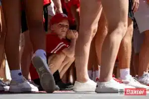 Nebraska Cornhusker fan hanging out in the shade waiting for the Huskers arrive to take on UTEP during the college football game Saturday, August 31, 2024, in Lincoln, Nebraska. Photo John S. Peterson.