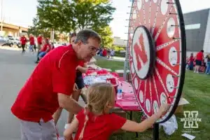 Nebraska Cornhusker fan spins the wheel for a prize before the match against the Texas A&M CC Islanders during the college volleyball game Friday, August 30, 2024, in Lincoln, Nebraska. Photo John S. Peterson.