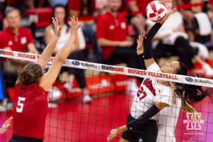 Nebraska Cornhusker Harper Murray (27) spikes the ball against Rebekah Allick (5) during the Red/White Volleyball Game Saturday, August 24, 2024, in Lincoln, Nebraska. Photo John S. Peterson.