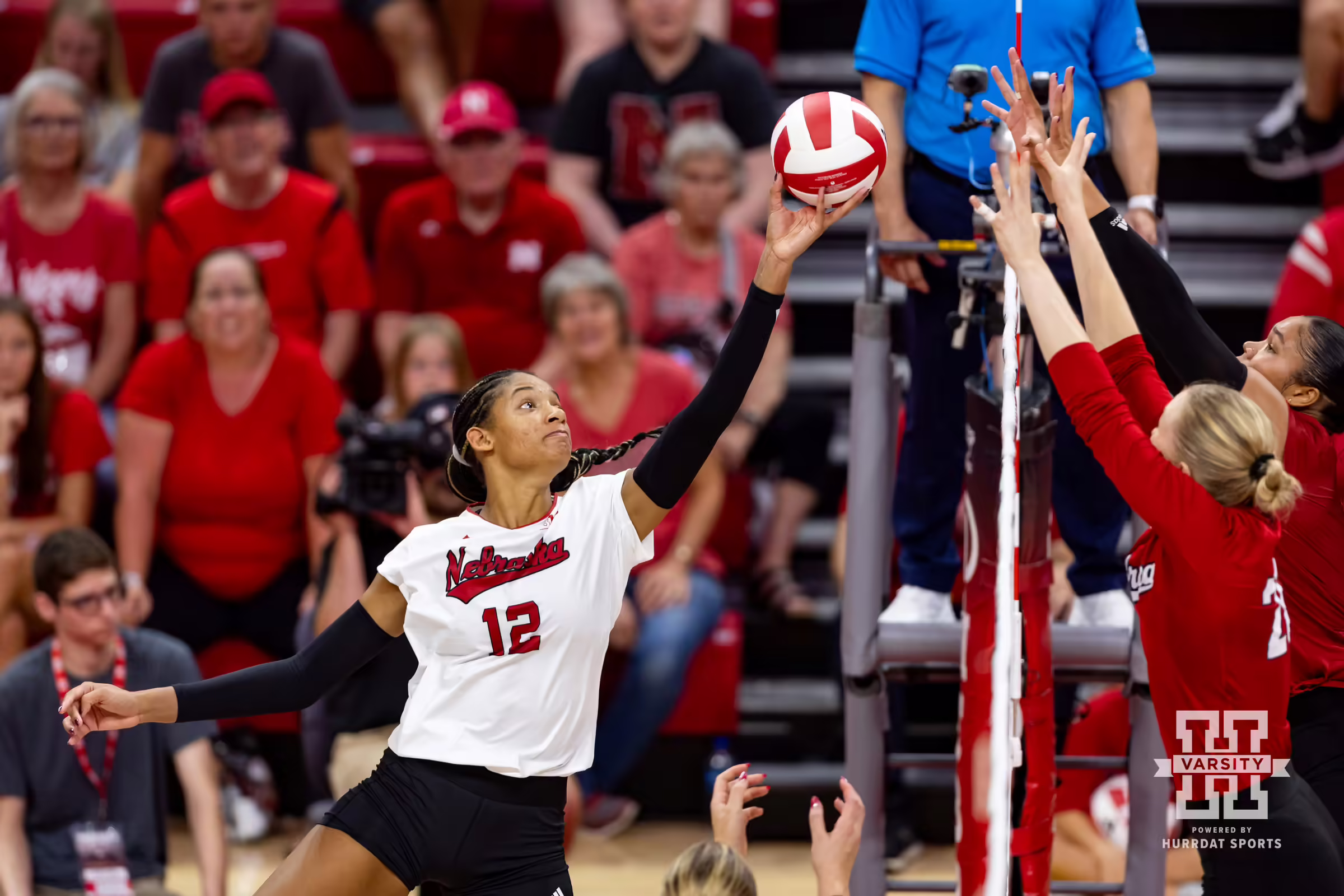 Nebraska Cornhusker Taylor Landfair (12) tips the ball against Lauren Stivrins and Kenndi Orr during the Red/White Volleyball Game Saturday, August 24, 2024, in Lincoln, Nebraska. Photo John S. Peterson.