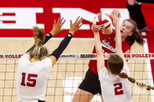 Nebraska Cornhusker Lindsay Krause (22) spikes the ball against Andi Jackson (15) and Bergen Reilly (2) during the Red/White Volleyball Game Saturday, August 24, 2024, in Lincoln, Nebraska. Photo John S. Peterson.