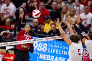 Nebraska Cornhusker Taylor Landfair (12) spikes the ball against Rebekah Allick (5) and Merritt Beason (13) during the Red/White Volleyball Game Saturday, August 24, 2024, in Lincoln, Nebraska. Photo John S. Peterson.