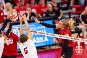 Nebraska Cornhusker Leyla Blackwell (11) spikes the ball against Rebekah Allick (5) and Harper Murray during the Red/White Volleyball Game Saturday, August 24, 2024, in Lincoln, Nebraska. Photo John S. Peterson.