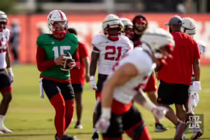 Nebraska Cornhusker Dylan Raiola (15) drops back to throw to Thomas Fidone II (24) during football practice Friday, August 16, 2024, in Lincoln, Nebraska. Photo John S. Peterson.