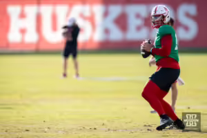 Nebraska Cornhusker Dylan Raiola (15) drops back to throw a pass during football practice Friday, August 16, 2024, in Lincoln, Nebraska. Photo John S. Peterson.