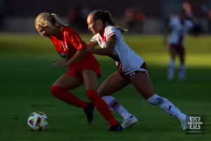 Nebraska Cornhusker forward Abbey Schwarz (6) battles for the ball against a Oklahoma St. Cowgirl during a college women's soccer match Friday, August 16, 2024, in Lincoln, Nebraska. Photo John S. Peterson.