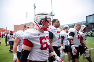 Nebraska Cornhusker Grant Brix (63) walking off the field with his teammates during football practice Friday, August 9, 2024, in Lincoln, Nebraska. Photo John S. Peterson.