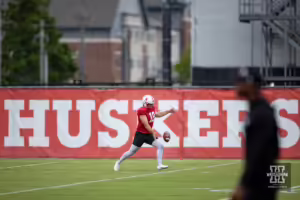 Nebraska Cornhusker Brian Buschini (18) punts the ball during football practice Friday, August 9, 2024, in Lincoln, Nebraska. Photo John S. Peterson.